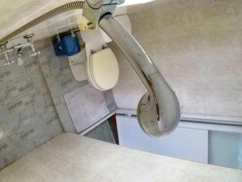 a bathroom with a toilet in a train at Surf House in La Gaulette