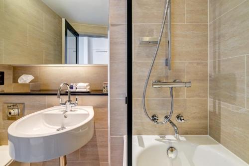 a bathroom with a sink and a shower at Apex Grassmarket Hotel in Edinburgh