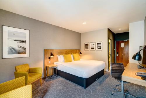 a hotel room with a bed and a desk at Apex Grassmarket Hotel in Edinburgh