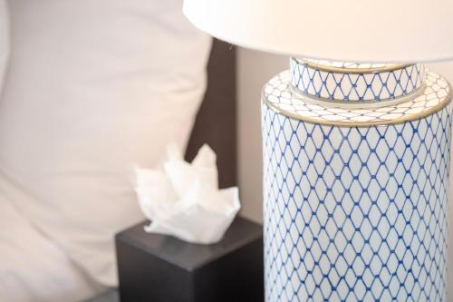 a blue and white night stand with a white lamp at Edgar Townhouse in Bath
