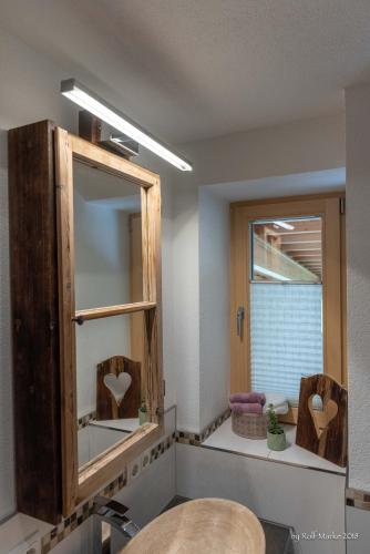 a bathroom with a mirror and a sink at Apartment Gehrenspitze in Reutte
