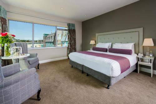a bedroom with a large bed and a window at Scott's Hotel in Killarney