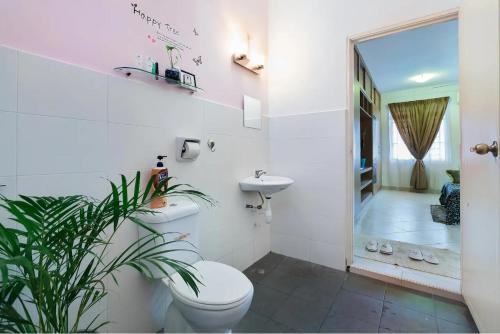 a white bathroom with a toilet and a sink at Family Suite@DESA TEBRAU *IKEA *AEON *TESCO *HERO in Johor Bahru