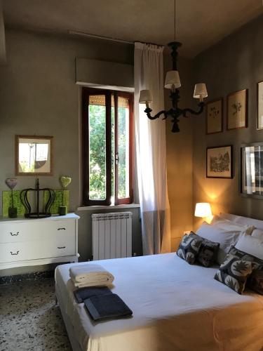 a bedroom with a large white bed and a window at La Casa di Zia Rita in Porto SantʼElpidio