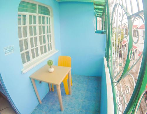 a small table in a room with a window at Nomads MNL Backpackers Homestay - near Airport in Manila