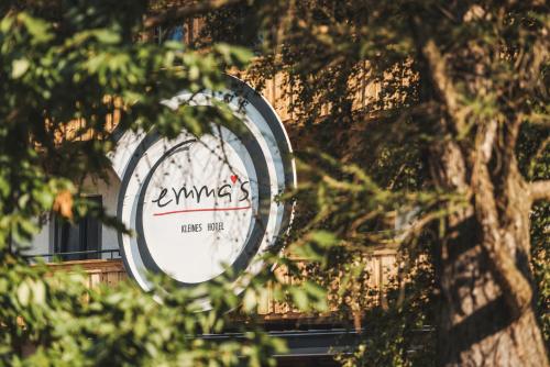 a sign on the side of a building with trees at Emma's kleines Hotel in Ramsau im Zillertal