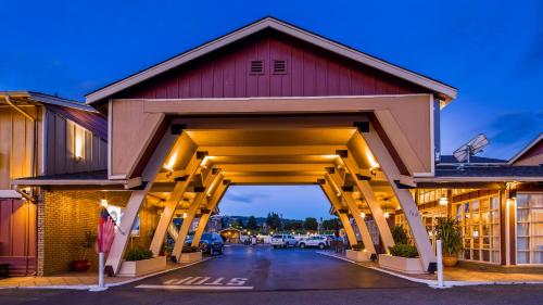 a covered parking lot with a red building at Best Western Garden Villa Inn in Roseburg