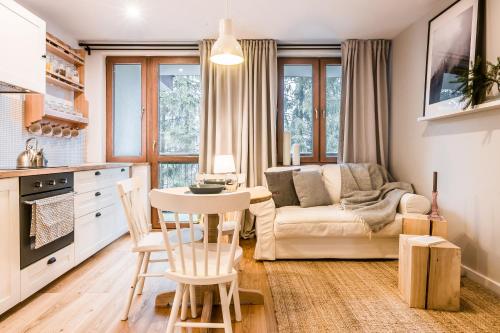 a kitchen and living room with a couch and a table at Giewont in Zakopane