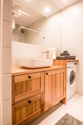 a bathroom with a sink and a washing machine at Giewont in Zakopane