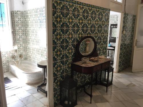 a bathroom with a sink and a mirror and a tub at BALNEARIO LA ENCARNACIÓN in Los Alcázares