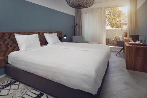Romantik Badhotel Renesseにあるベッド