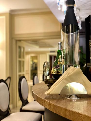 a table with a bottle of champagne and a glass at Hotel Miramare & Spa in Sestri Levante
