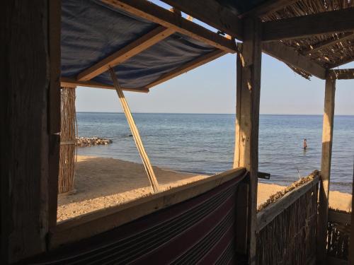 a view of the beach from a house window at Sina Star Camp in Nuweiba