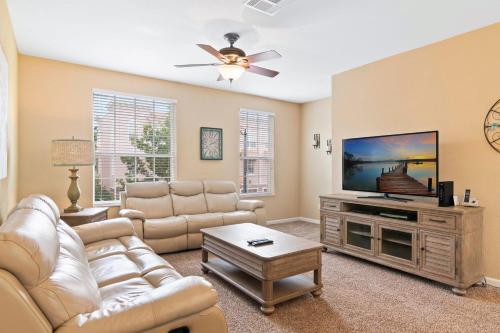 a living room with a couch and a flat screen tv at Orlando Resort Rentals at Universal Boulevard in Orlando