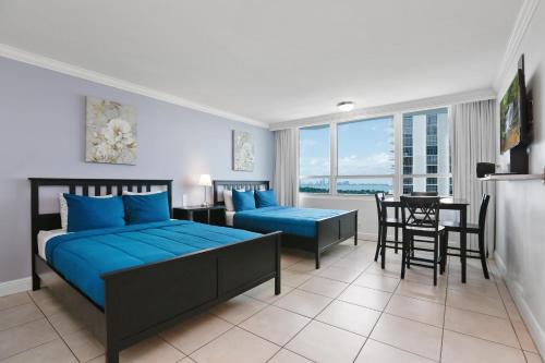 a bedroom with a bed and a table and chairs at Miami Beach Apartments by MiaRentals in Miami Beach