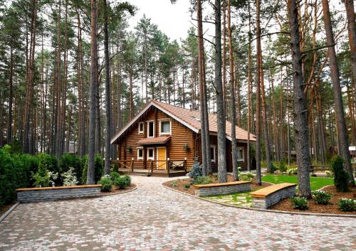 a log cabin in the middle of a forest at Okka Holiday Home in Alajõe