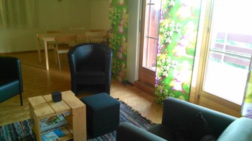 a living room with a table and a chair and a table at La Petite Fleur in Enges