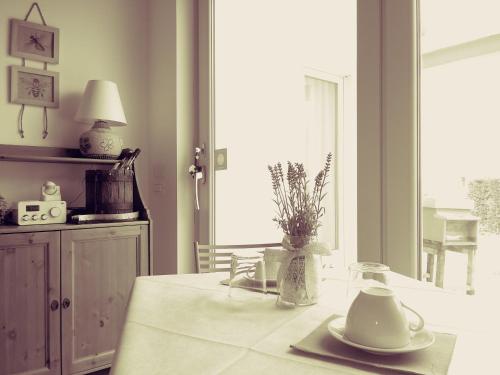 a kitchen with a table with a vase on it at Agriturismo Honey Farm in Piazzola sul Brenta