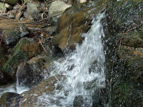 a stream of water coming out of a rock at Аня Рома in Lazeshchyna