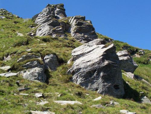 a rocky mountain with green grass and a blue sky at Аня Рома in Lazeshchyna
