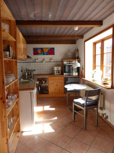 a kitchen with a table and a table and chairs at Alter Krämerladen von 1732 in Friedrichstadt
