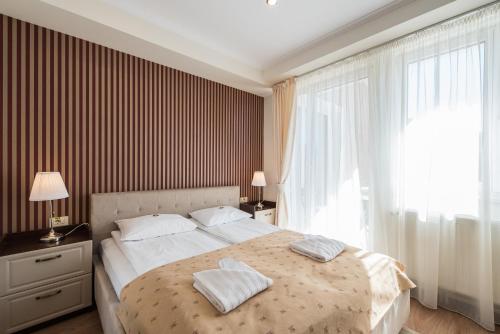 a bedroom with a large bed with two pillows on it at Pensiunea David in Târgu-Mureş