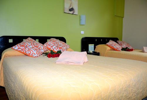 a bed with a pink shirt on top of it at Hostal Terra 1 - ANDALUCÍA in Quito