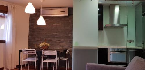 a kitchen with a table with chairs and a counter top at Santa Ursula in Toledo