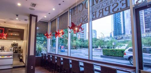 a restaurant with benches in front of a window at Century Plaza Hotel in Vancouver