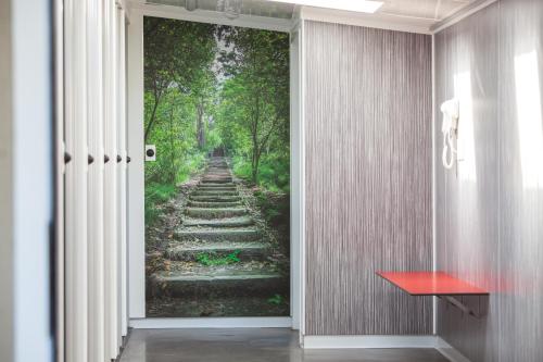 an entrance to a hallway with a wall mural of a dirt road at Taupo Debretts Spa Resort in Taupo