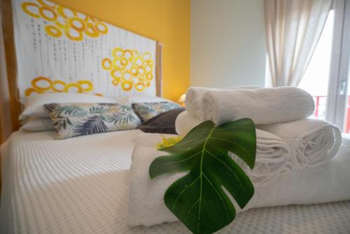 a bedroom with a bed with towels and a plant at Sea Station in Polignano a Mare