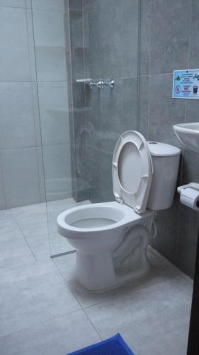 a bathroom with a toilet and a glass shower at Vivienda turística mi sueño Jardín in Jardin