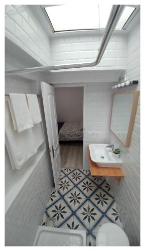 a bathroom with a sink and a toilet and a mirror at Casa Lagunera in Las Lagunas