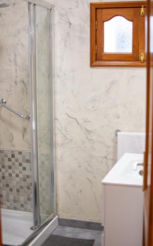 a bathroom with a shower and a sink at Ayfa Apartment in Punta de Mujeres