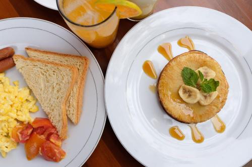 two plates of breakfast food with toast and scrambled eggs at Mount Sea View Bungalow in Nusa Penida