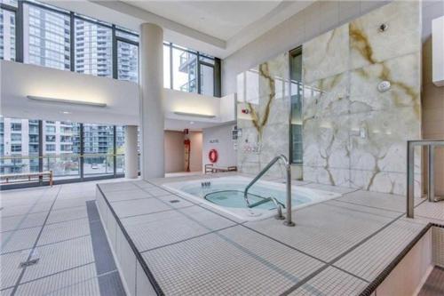 a large bathroom with a tub in a building at Lakefront living Downtown Toronto - Free Parking and Gym in Toronto