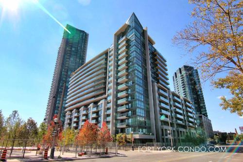 a tall building in front of two tall buildings at Lakefront living Downtown Toronto - Free Parking, Gym, Indoor Pool in Toronto
