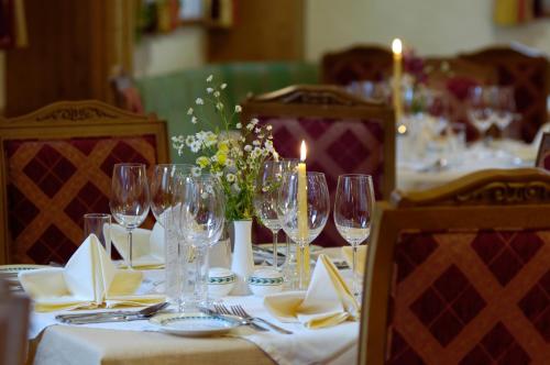 a table set with wine glasses and napkins and candles at Hotel Donauhof in Emmersdorf an der Donau