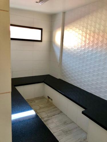 a room with a bench in a prison cell at Flat Partic Hotel Jurere Beach Village in Florianópolis