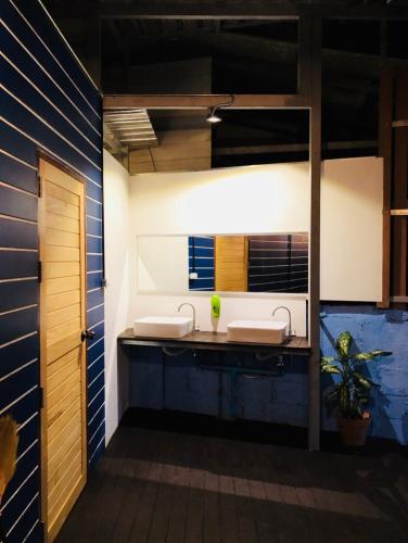 a bathroom with two sinks and a mirror at Petit Suncliff Resort in Haad Rin