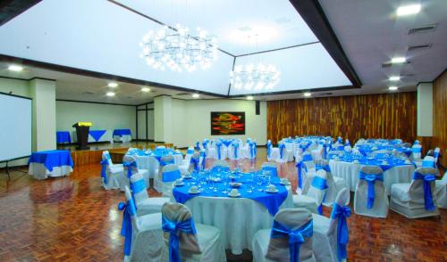 a banquet hall with blue and white tables and chairs at Hotel Ambassador in San José