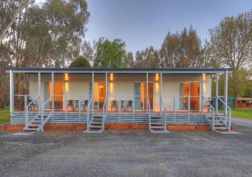 a house with orange doors and a porch at Yea Riverside Caravan Park in Yea