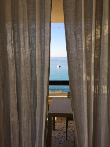 a room with a window with a view of the ocean at Seafront in Karistos
