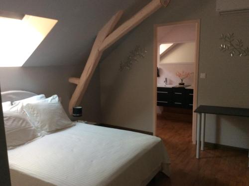 a bedroom with a bed and a skylight at GITE des teilles in Carlux