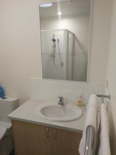 a bathroom with a sink and a mirror at Villa 28 Cape Villas in Dunsborough