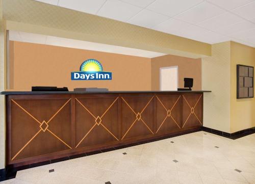a waiting area at a days inn sign in a lobby at Days Inn by Wyndham Silver Spring in Silver Spring