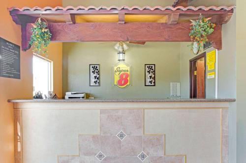 a bar in a restaurant with a mirror at Super 8 by Wyndham Tucson Downtown Convention Center in Tucson