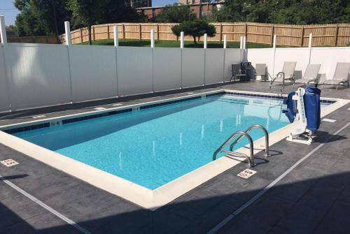 a large swimming pool with a fence at Wingate by Wyndham Louisville Airport Expo Center in Louisville
