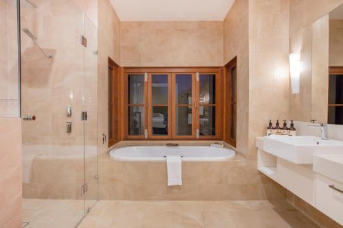 a bathroom with a tub and a sink and a shower at Spicers Vineyards Estate in Pokolbin