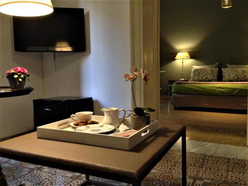 a room with a table with a tray of food on it at A Casa di Amelie in Palermo